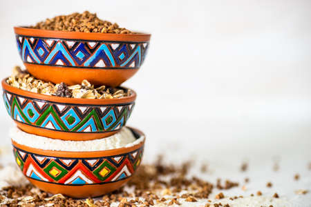 Organic superfood concept with raw  buckwheat, oatmeal and corn flour on wooden backgroundの写真素材