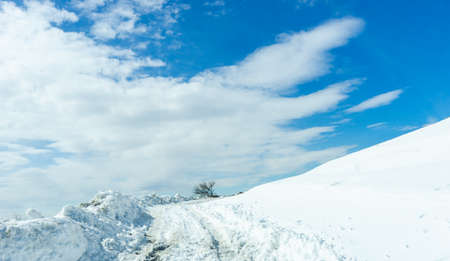 Blue winter sky and road in mountain, winter time in Caucasus mountain range close to Tbilisi, Georgiaの写真素材