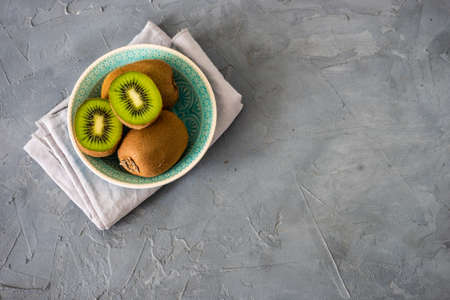 Ripe organic kiwi fruits on rustic background with copy spaceの写真素材