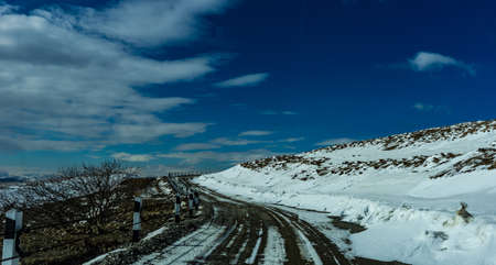 Blue winter sky and road in mountain, winter time in Caucasus mountain range close to Tbilisi, Georgiaの写真素材