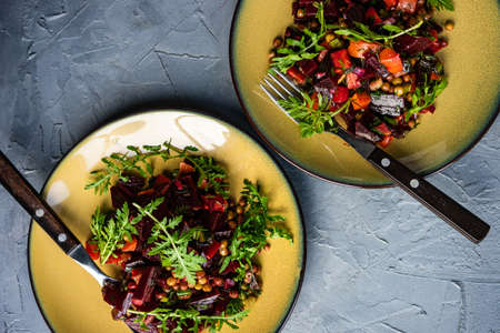 Vegetable salad with beetroot and rocket herb on rustic background with copy spaceの写真素材