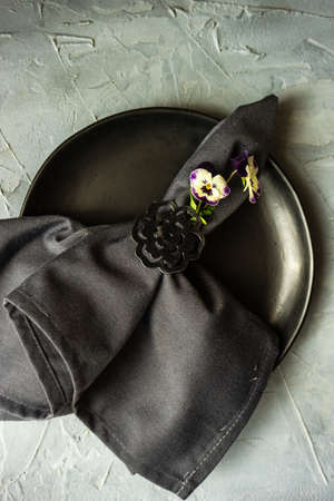 Table setting for holiday easter dinner decorated with spring viola flowersの写真素材