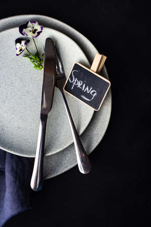 Table setting for holiday easter dinner decorated with spring viola flowers