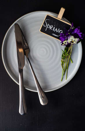 Table setting for holiday easter dinner decorated with spring viola flowersの写真素材