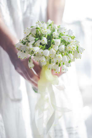 Beautiful bridal bunch with white spring snowdrop flowersの写真素材