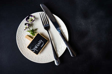 Table setting for holiday easter dinner decorated with spring viola flowers
