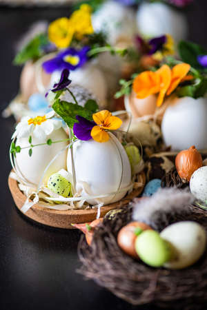 Easter holiday natural composition with first spring flowers like tricolor violas and primerose ,...