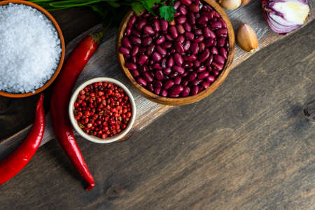 Cooking concept with organic beans in a bowl and ingredients for lobio dishの写真素材