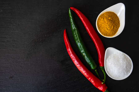 Sea salt, pepper powder on rustic background as a organic food backgroundの写真素材