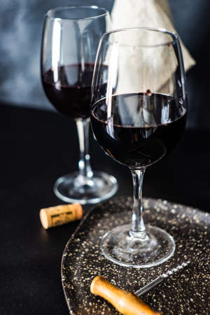 Bottle of wine and glass on concrete background with copy space