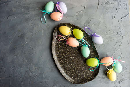 Festive table setting for Easter holiday dinner decorated with flowers and eggsの写真素材