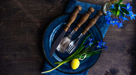 Spring table setting with blue scilla siberica flowers on concrete background with copy spaceの写真素材