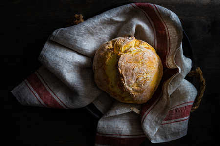 Homemade healthy bread on vintage towel on a table with copy space