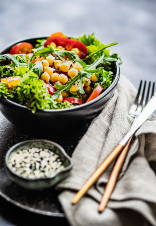 Summer salad with organic vegetables like a tomatoes, pepper, rocket and cucumberの写真素材