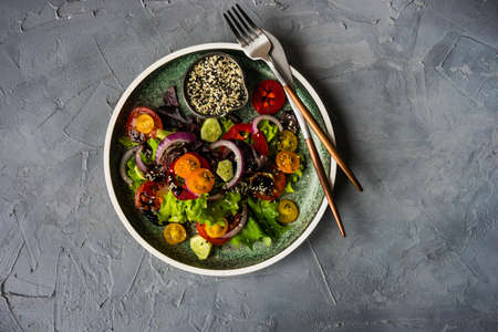 Summer salad with organic vegetables like a tomatoes, pepper, rocket and cucumberの写真素材