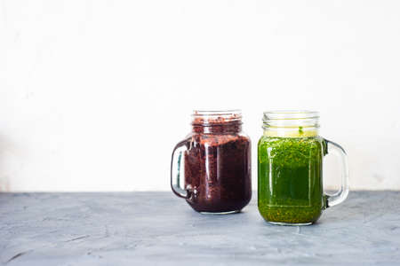 Organic vegetable smoothie with spinach and chia seeds on rustic background with copy space
