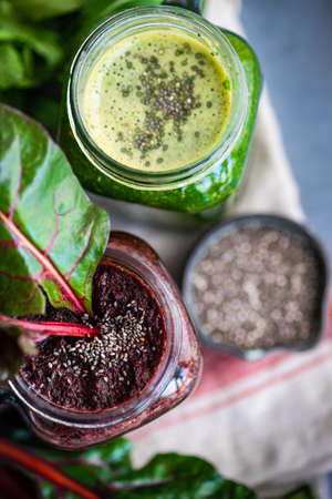 Organic vegetable smoothie with spinach and chia seeds on rustic background with copy space