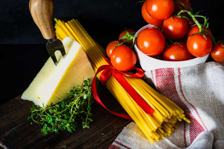 Italian pasta ingredients on rustic background with copy spaceの写真素材