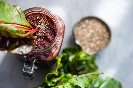 Organic vegetable smoothie with spinach and chia seeds on rustic background with copy space