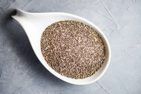 Organic chia seeds on dark wooden table with copyspaceの写真素材