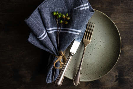 Spring table setting in rustic style decorated with cherry bloom tree branches