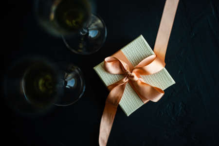 White sparkling wine and gift box concept on grey concrete background with copy spaceの写真素材