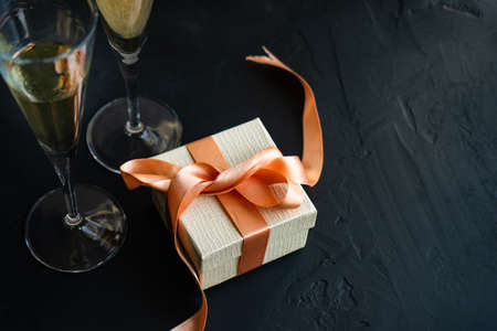 White sparkling wine and gift box concept on grey concrete background with copy spaceの写真素材