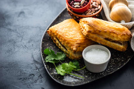 Traditional georgian lobiani pie with beans and herbs on rustic background with copy spaceの写真素材