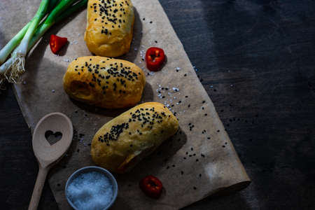 Traditional georgian pies with chicken meat, bell pepper and herbs  on dark wooden backgroundの写真素材