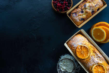 Sweet dessert concept with berries and orange cakes  in nice interiorの写真素材