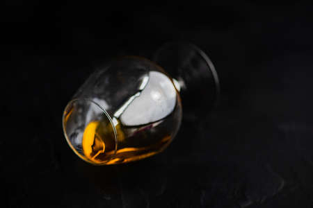 Alcohol drink concept with glass of cognac on dark background with copy space