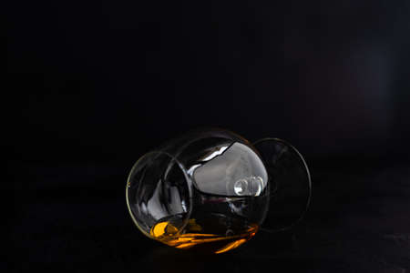 Alcohol drink concept with glass of cognac on dark background with copy space