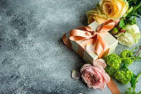 Beautiful floral card concept with fresh roses on concrete background with copy spaceの写真素材