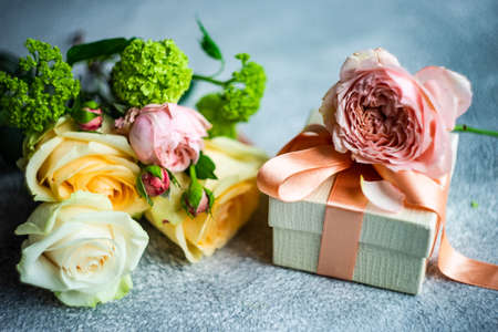 Beautiful floral card concept with fresh roses on concrete background with copy spaceの写真素材