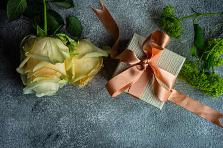 Beautiful floral card concept with fresh roses on concrete background with copy spaceの写真素材