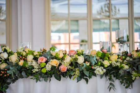 Floral wedding composition with seasonal flowers and greens as a place decor for wedding ceremonyの写真素材