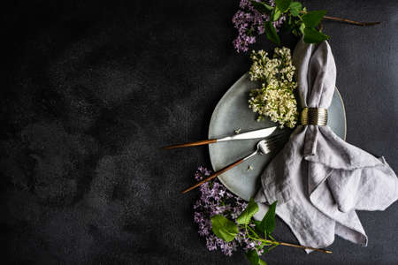 Spring table setting with beautiful lilac flowers on grey concrete background with copy spaceの写真素材