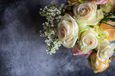 Beautiful floral card concept with fresh roses on concrete background with copy spaceの写真素材