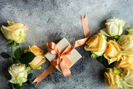 Beautiful floral card concept with fresh roses on concrete background with copy spaceの写真素材