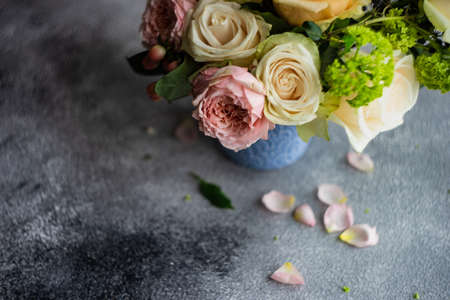 Beautiful floral card concept with fresh roses on concrete background with copy spaceの写真素材
