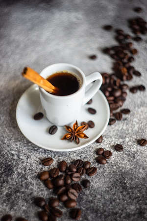 Cup of morning coffee with cinnamon stics and anise star as a drink concept with copy spaceの写真素材