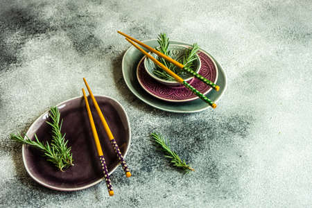 Asian style table setting with chopsticks on grey background with copy spaceの写真素材