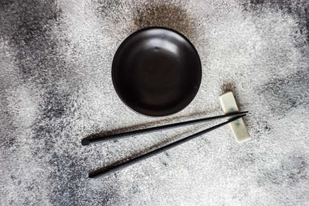 Asian style table setting with chopsticks on grey background with copy spaceの写真素材