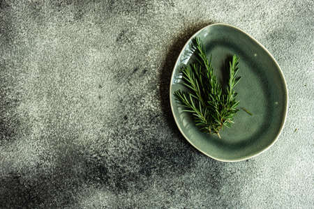 Table setting with fresh rosemary on dark stone table with copy spaceの写真素材