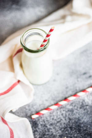 Vintage bottle of milk on grey background with copy spaceの写真素材