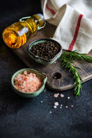 Variety of spices on dark concrete background with copy space