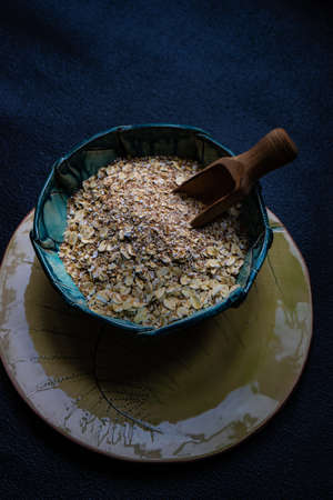 Healthy food concept with oats meal on dark rustic background with copyspace