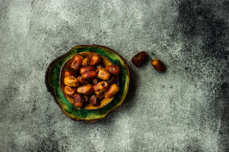 Raw Organic Medjool Dates Ready to Eat on dar wooden tableの写真素材
