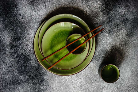 Asian table setting with chopsticks on stone  background with copy spaceの写真素材