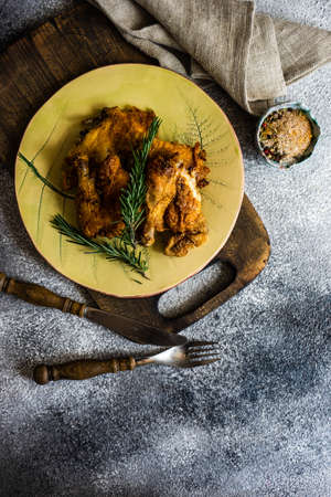 Served grilled chicken with spices and rosemary on stone background with copy spaceの写真素材